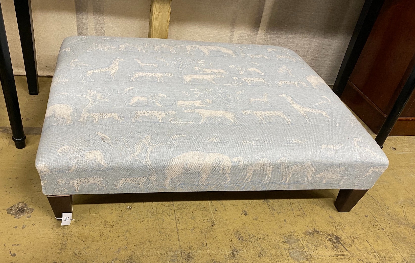 A contemporary rectangular footstool upholstered in Andrew Martin animal print fabric, width 103cm, height 80cm